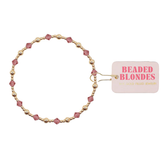Beaded bracelet with pink and gold beads on a white background, featuring a 'Beaded Blondes' tag.
