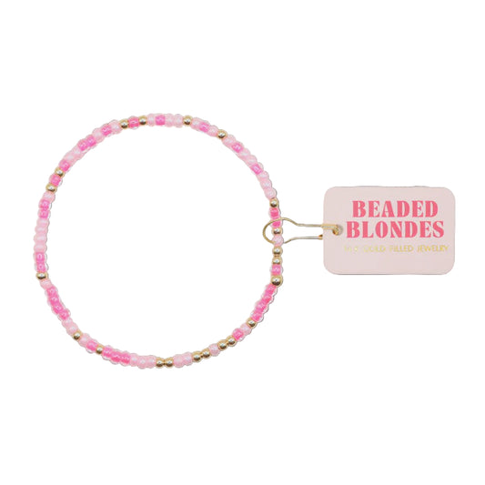 Pink beaded hair tie with a 'Beaded Blondes' tag on a white background