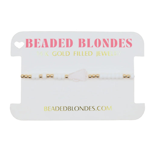Beaded Blondes jewelry display card with gold necklaces on a black background