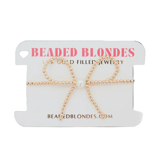 Gold beaded necklace on a 'Beaded Blondes' branded card with a white background