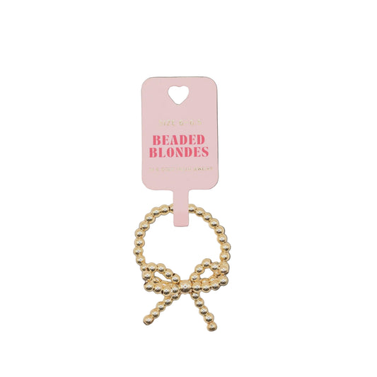 Gold beaded hair tie on a pink 'Beaded Blondes' card against a white background