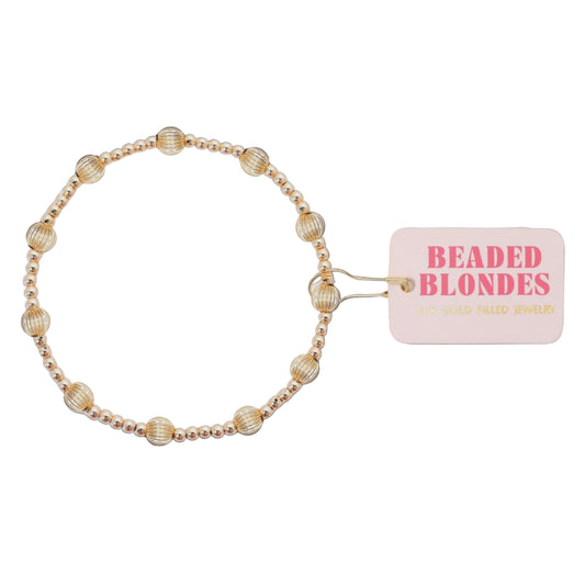 Beaded hair accessory with 'Beaded Blondes' tag on a white background