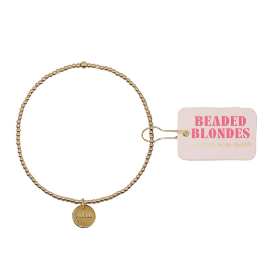 Gold beaded necklace with a tag labeled 'Beaded Blondes' on a white background