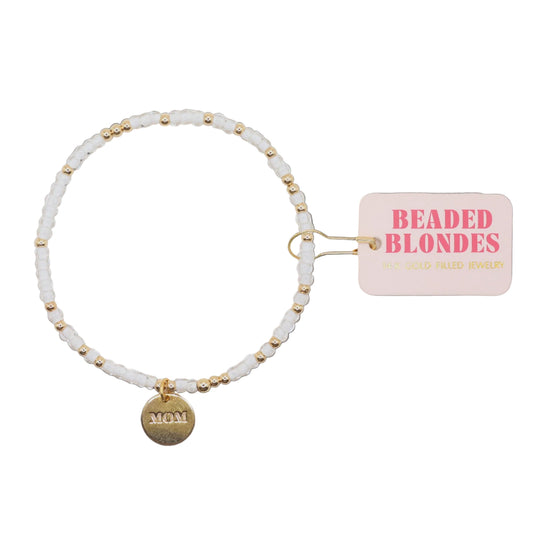 Bracelet with 'MOM' charm and 'Beaded Blondies' tag on a white background
