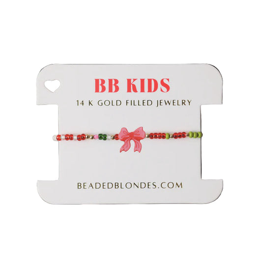 Children's bracelet with a pink bow on a 'BB Kids' branded card.