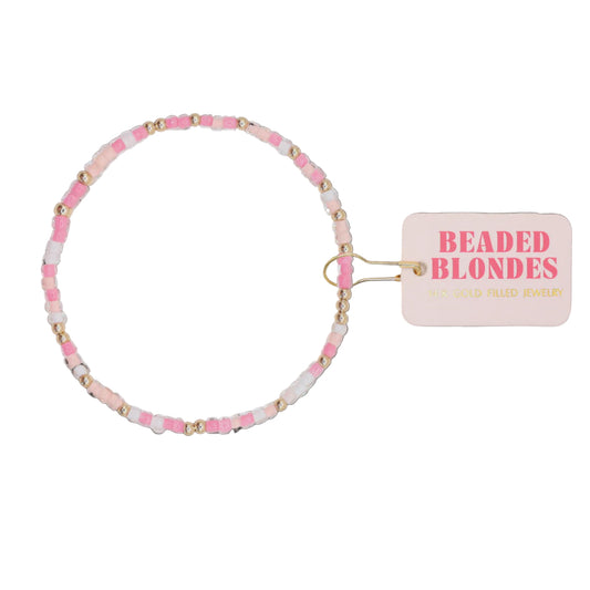 Beaded bracelet with pink and gold beads on a white background, featuring 'Beaded Blondes' brand tag.