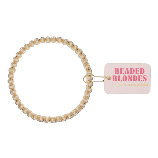 Beaded hair tie with a 'Beaded Blondes' tag on a white
background