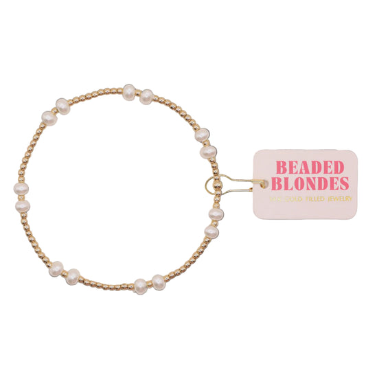 Pearl hair tie with 'Beaded Blondes' tag on a white background