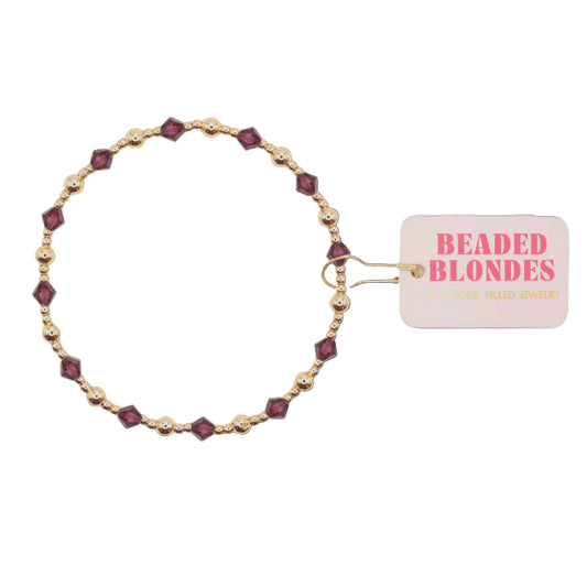 Beaded bracelet with purple beads on a white background, featuring a 'Beaded Blondes' tag.
