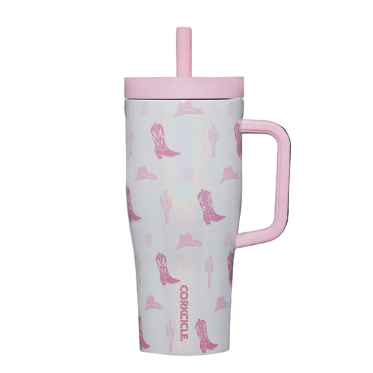 Travel mug with pink handle and cowboy boot pattern on a white background