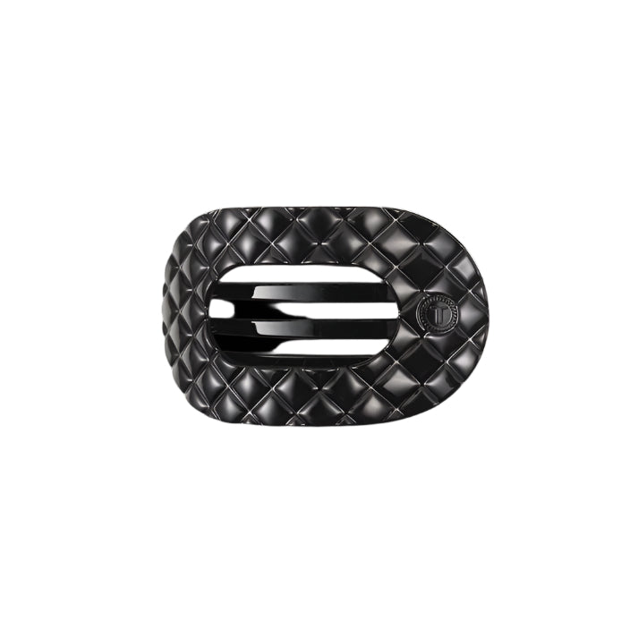 Black quilted hair clip with a brand logo on a white background