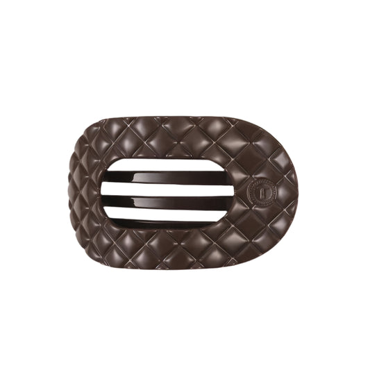 Brown quilted hair clip with a brand logo on a white background