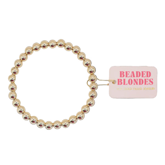 Gold beaded bracelet with a 'Beaded Blondes' tag on a white  background