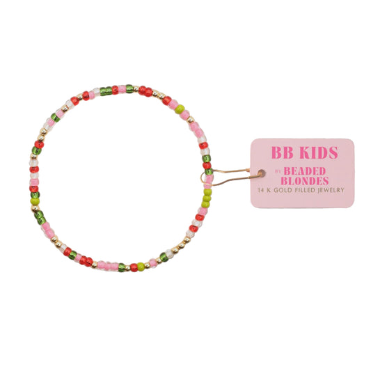 Colorful beaded hair tie with a pink label on a white background