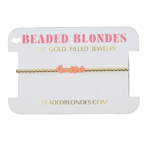 Beaded Blondes jewelry card with a gold bracelet on a white background