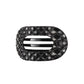 Black quilted hair clip with a brand logo on a white background
