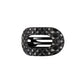 Black quilted hair clip with a brand logo on a white background
