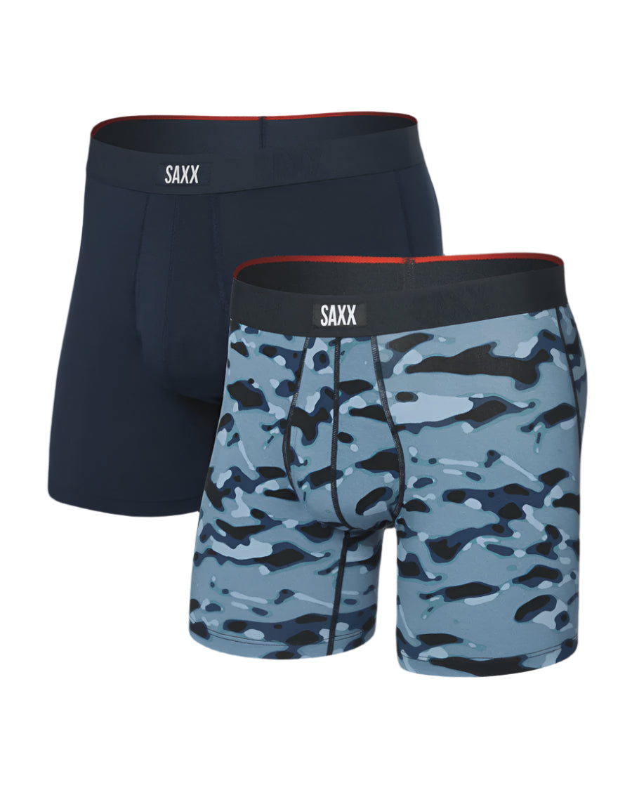Two pairs of SAXX underwear, one navy and one camouflage, on a white background.