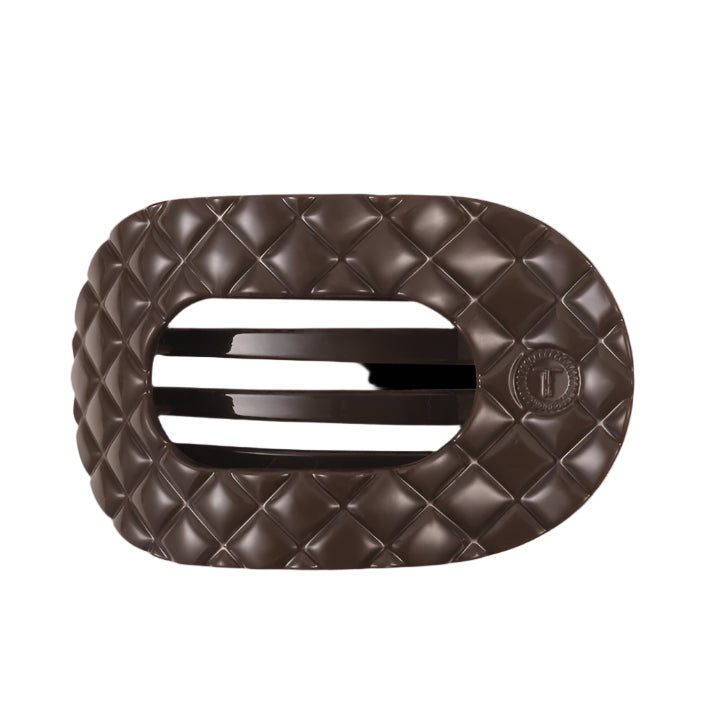 Brown quilted hair clip with a brand logo on a white background
