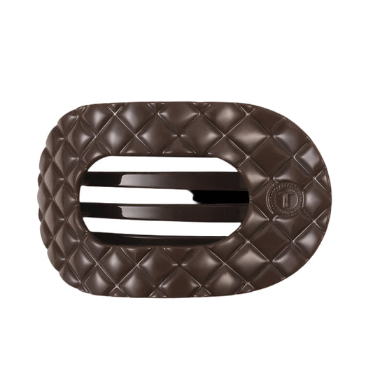 Brown quilted hair clip with a brand logo on a white background
