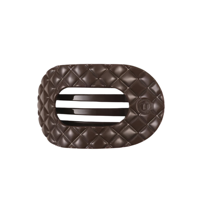 Brown quilted hair clip with a brand logo on a white background
