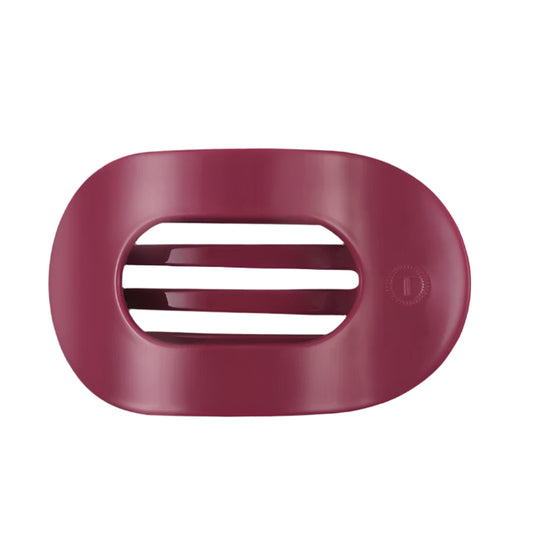 Pink hair clip with a brand logo on a white background
