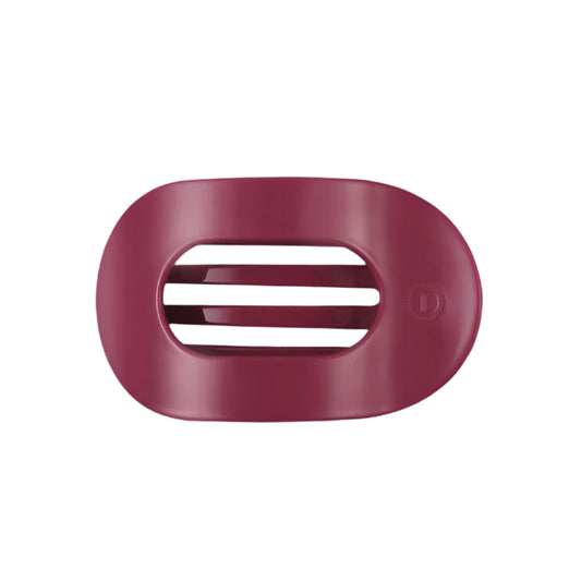 Pink hair clip with a brand logo on a white background
