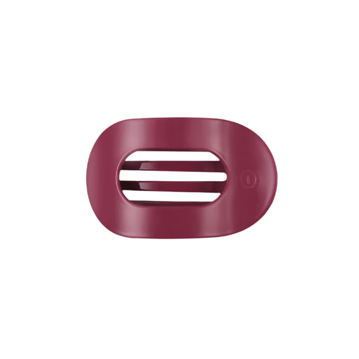 Pink hair clip with a brand logo on a white background
