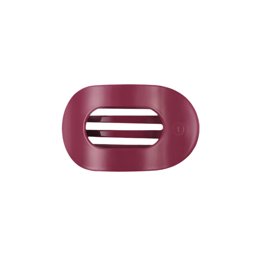 Pink hair clip with a brand logo on a white background
